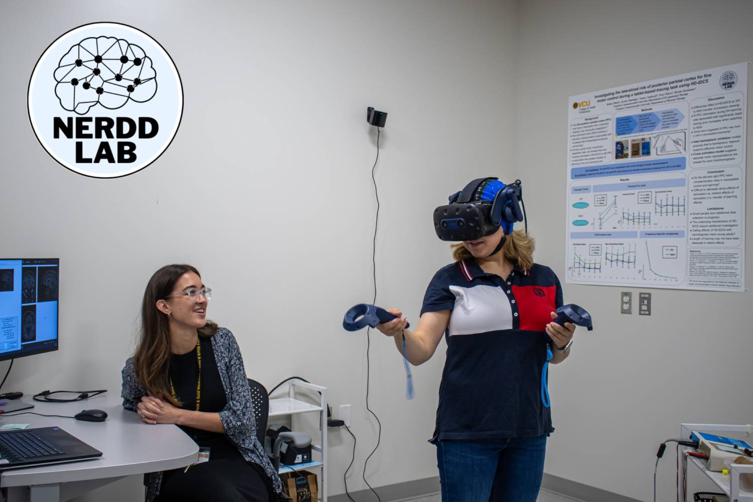 Dr Brooke Dexheimer and VR participant wearing an electrode cap and VR headset in the NERDD lab