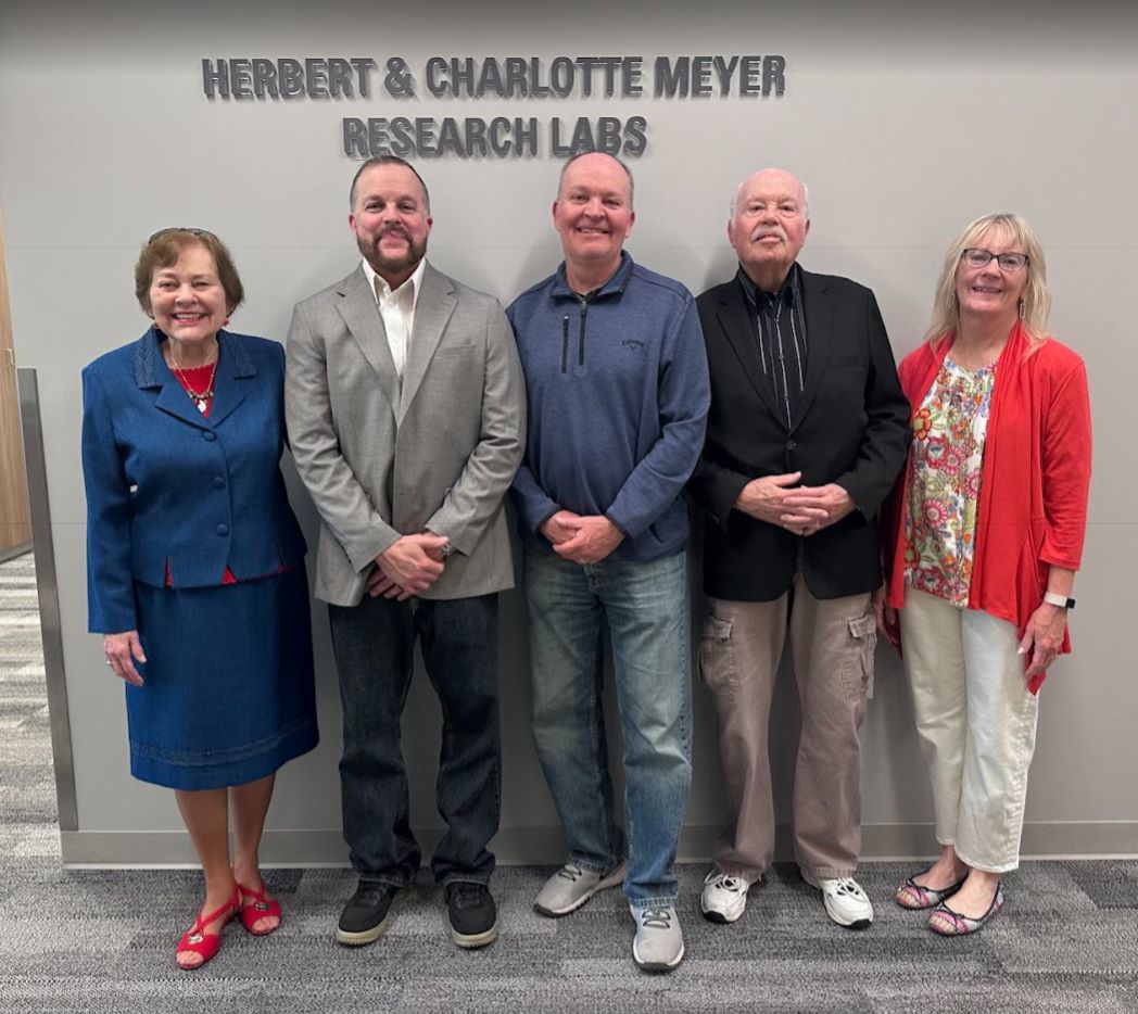 Dalness family in front of Herbert and Charlotte Meyer research labs