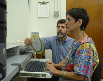 two adults working together at a computer